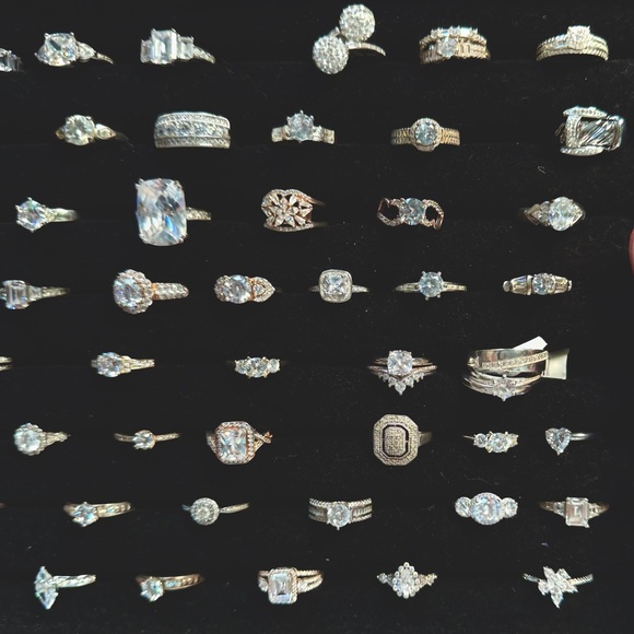 Tray of sterling silver engagement rings in various sizes.